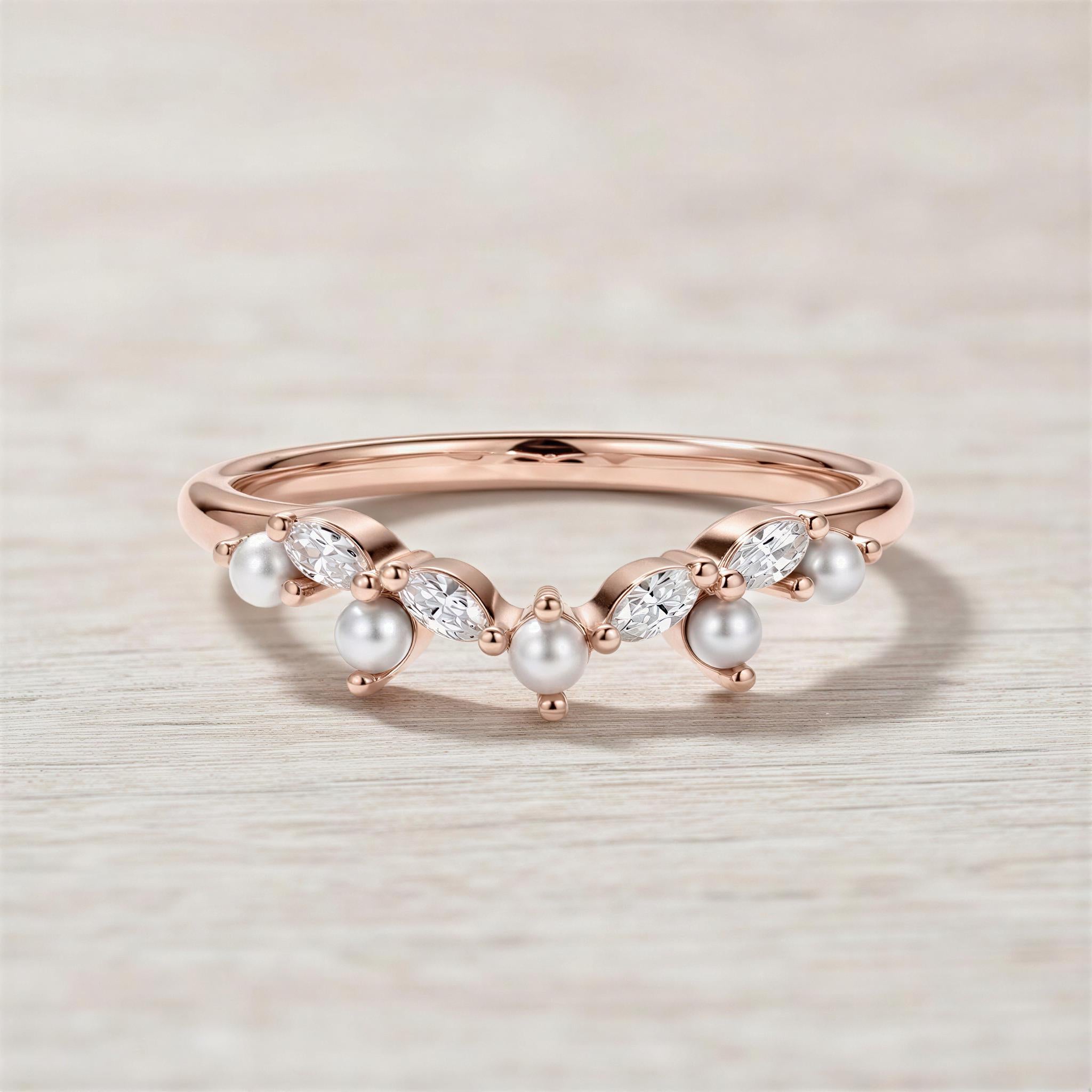 A rose gold ring with a halo of pearls and diamonds set in the center.