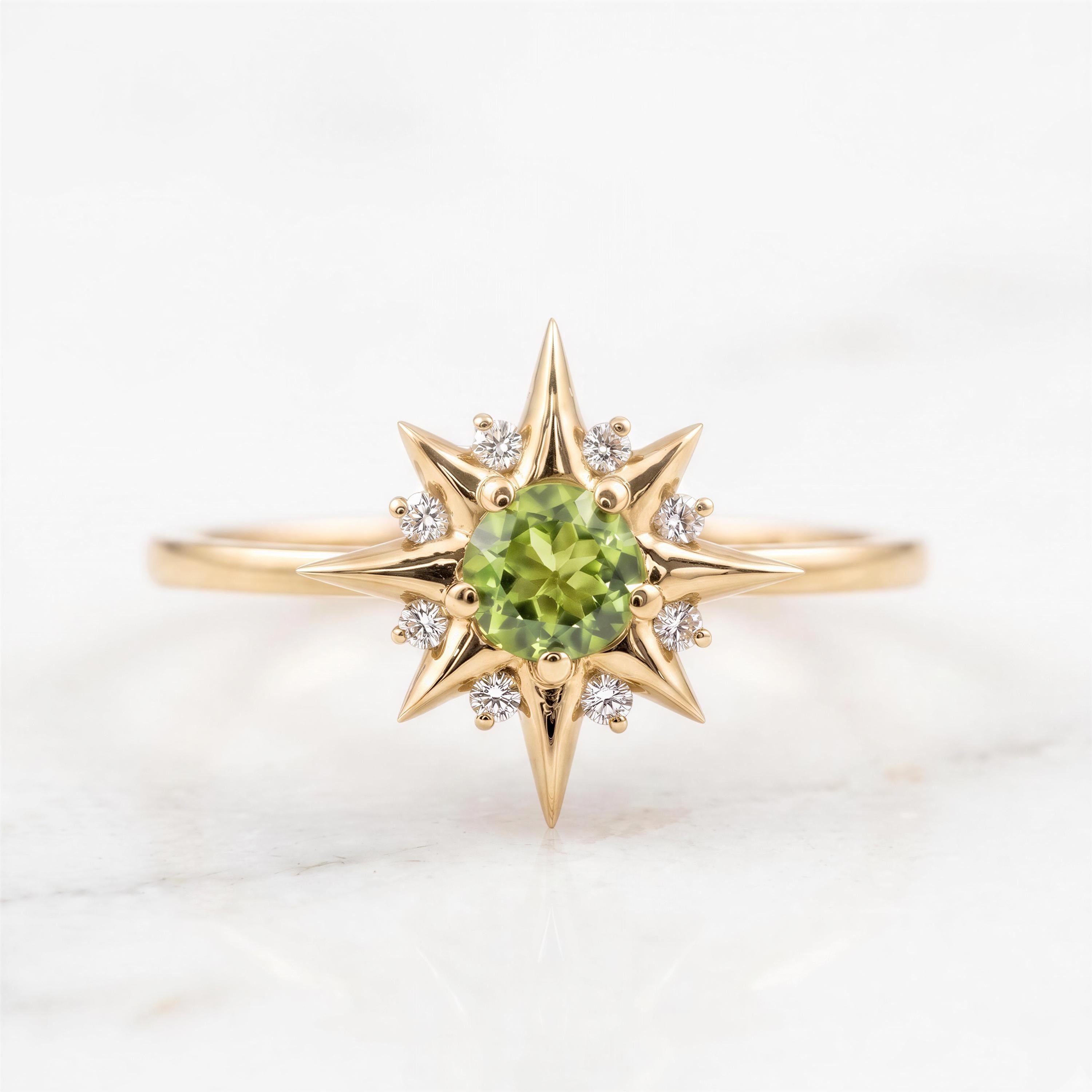 A gold ring with a large central green gemstone surrounded by smaller diamonds, resembling a starburst design.