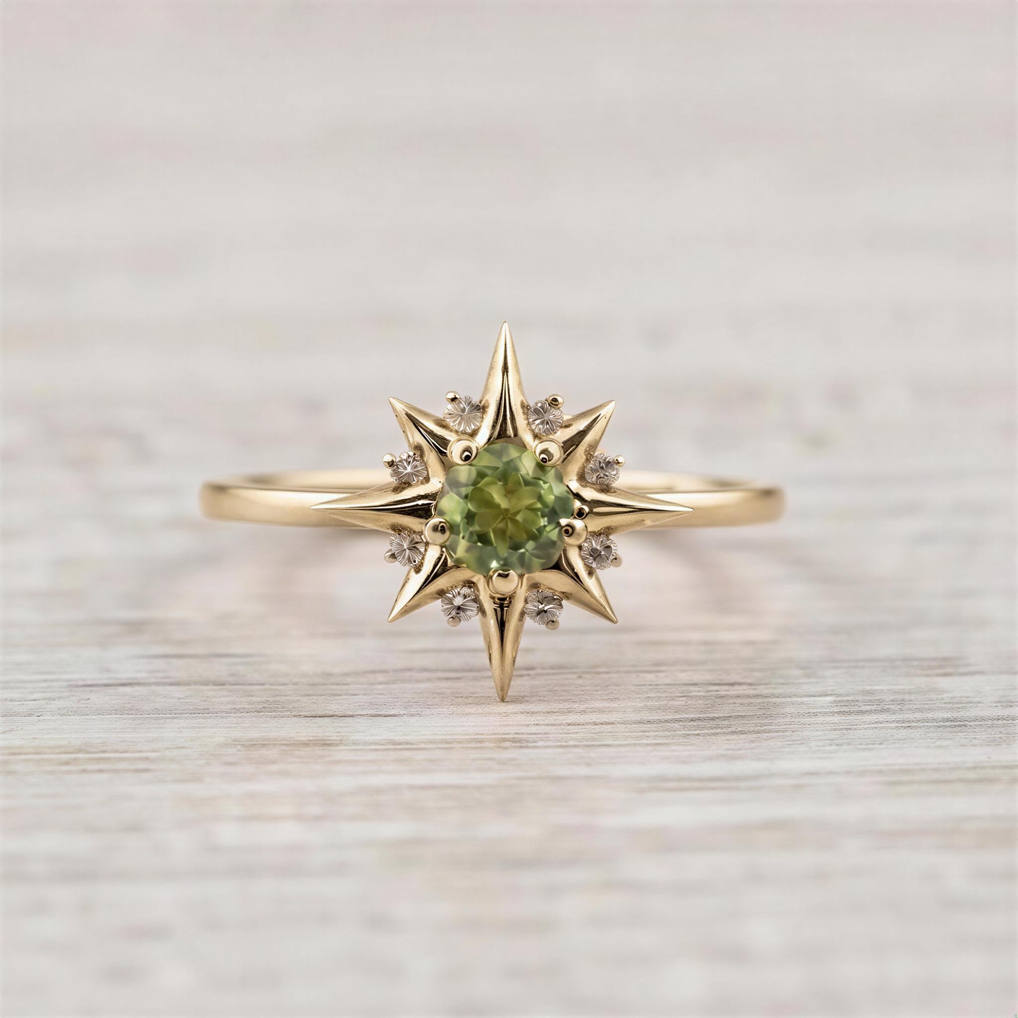 A gold ring with a large central gemstone surrounded by smaller diamonds, resembling a starburst design.