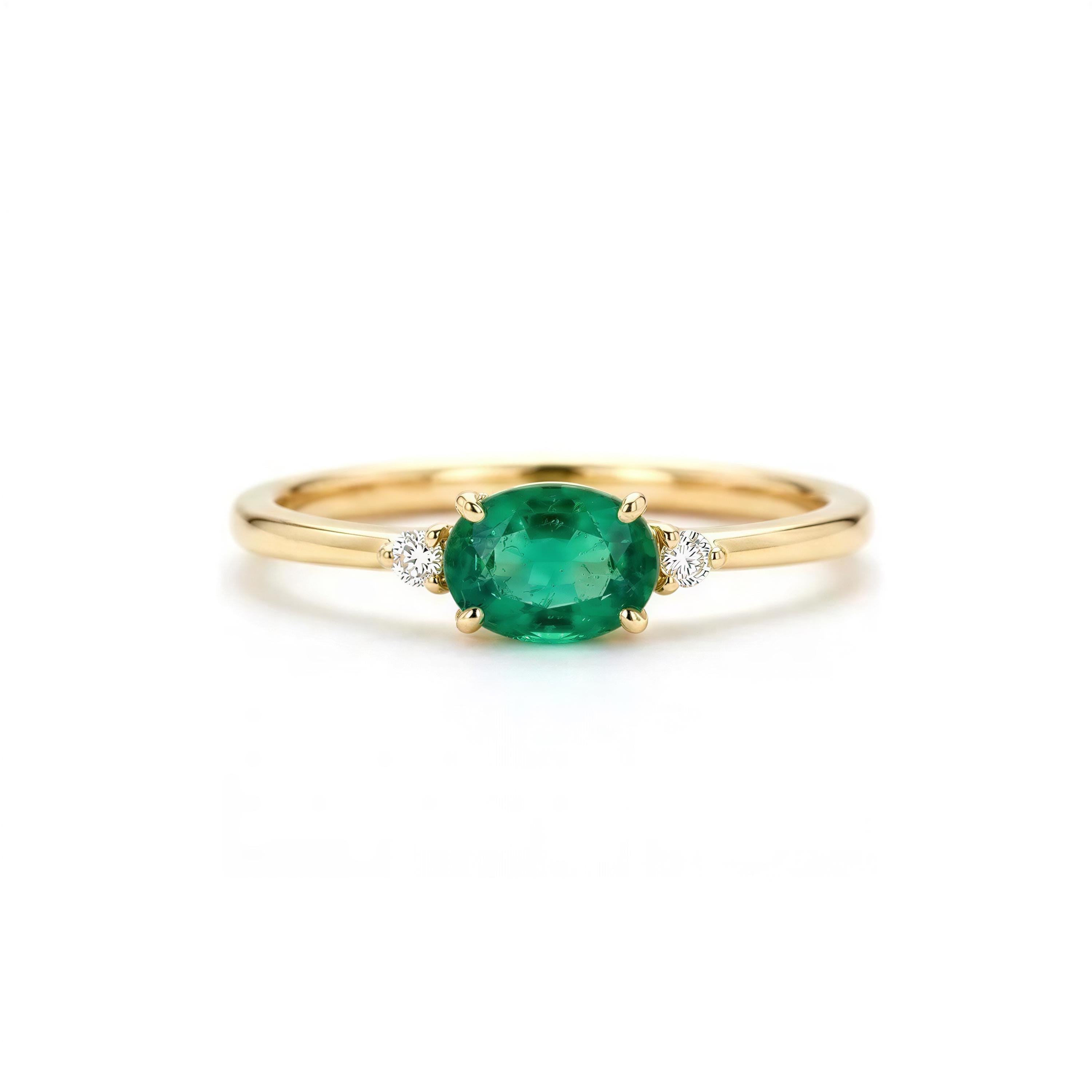 A gold ring with a large oval-shaped green gemstone in the center, surrounded by smaller diamonds.