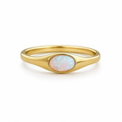 A gold ring with a large oval-shaped opal stone set in the center.