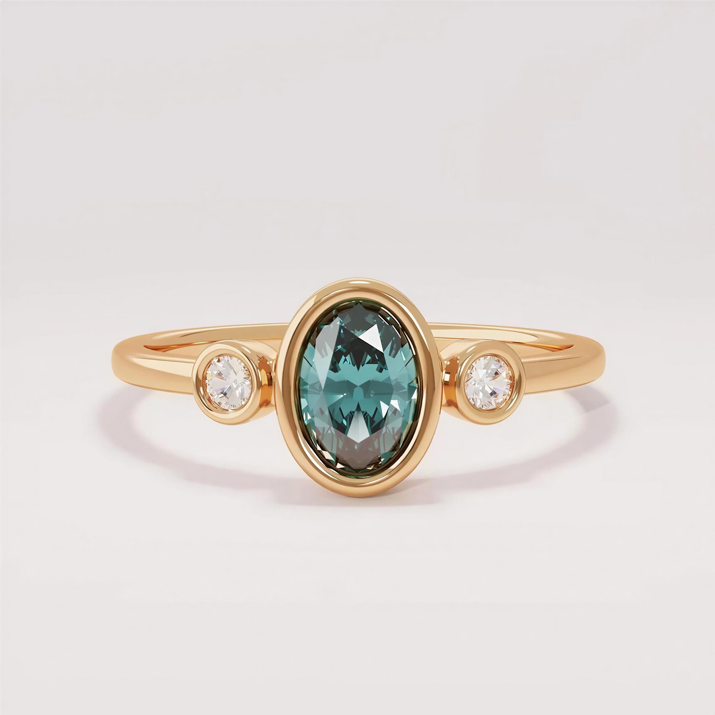 A gold ring with a large oval-shaped gemstone in the center, surrounded by smaller diamonds on either side.