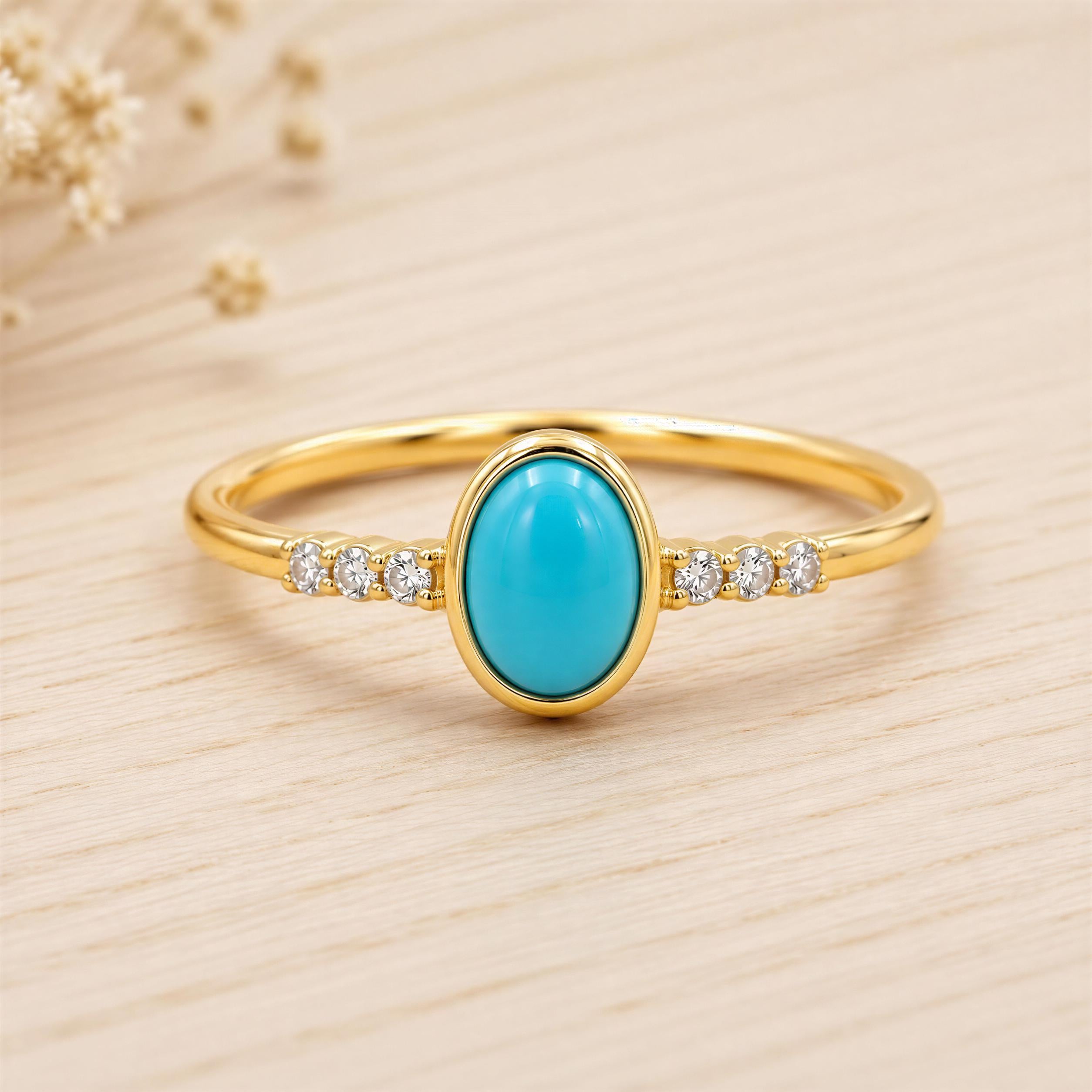 A gold ring with a turquoise stone set in the center, surrounded by small diamonds.