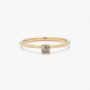 A simple gold ring with a small diamond set in the center.