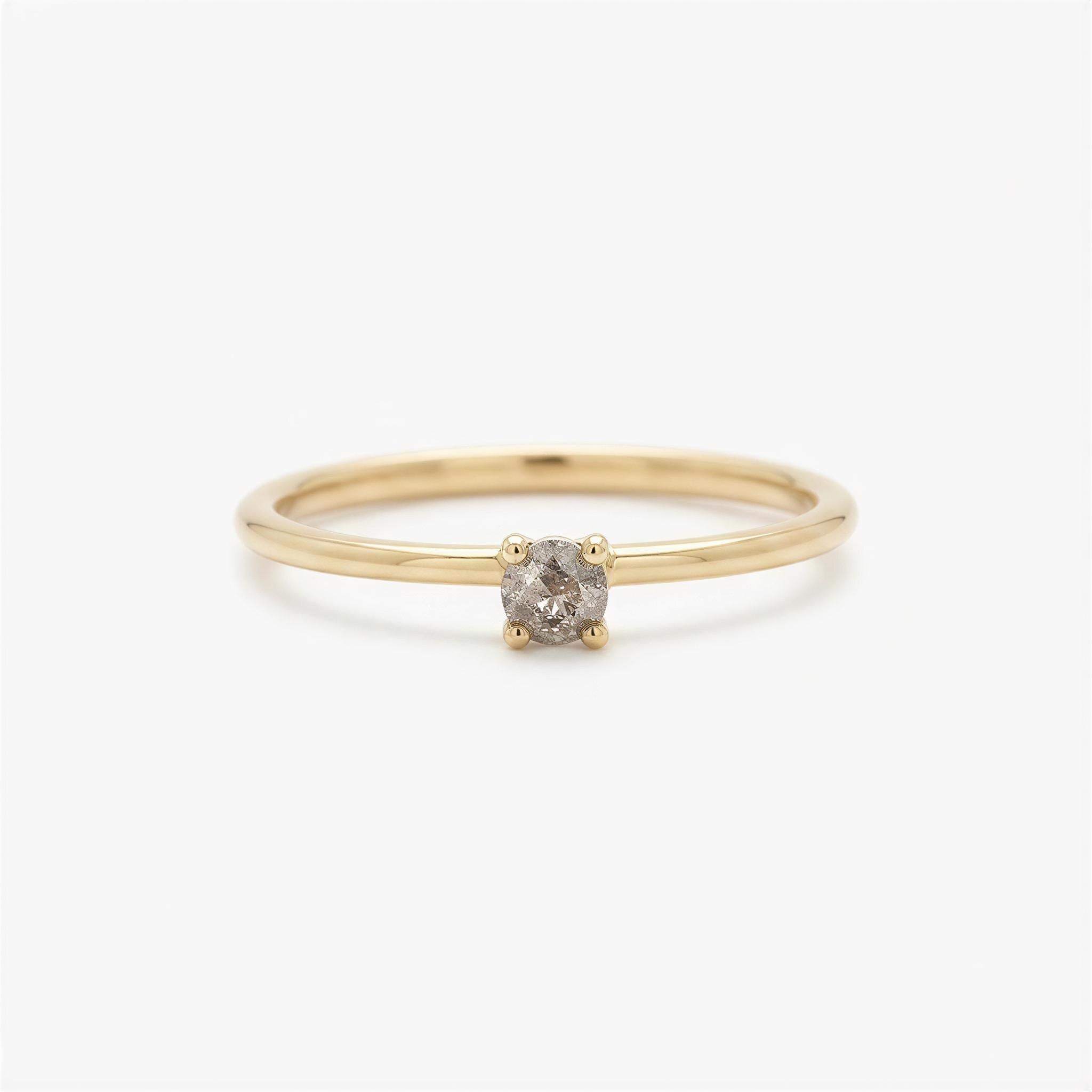 A simple gold ring with a small diamond set in the center.