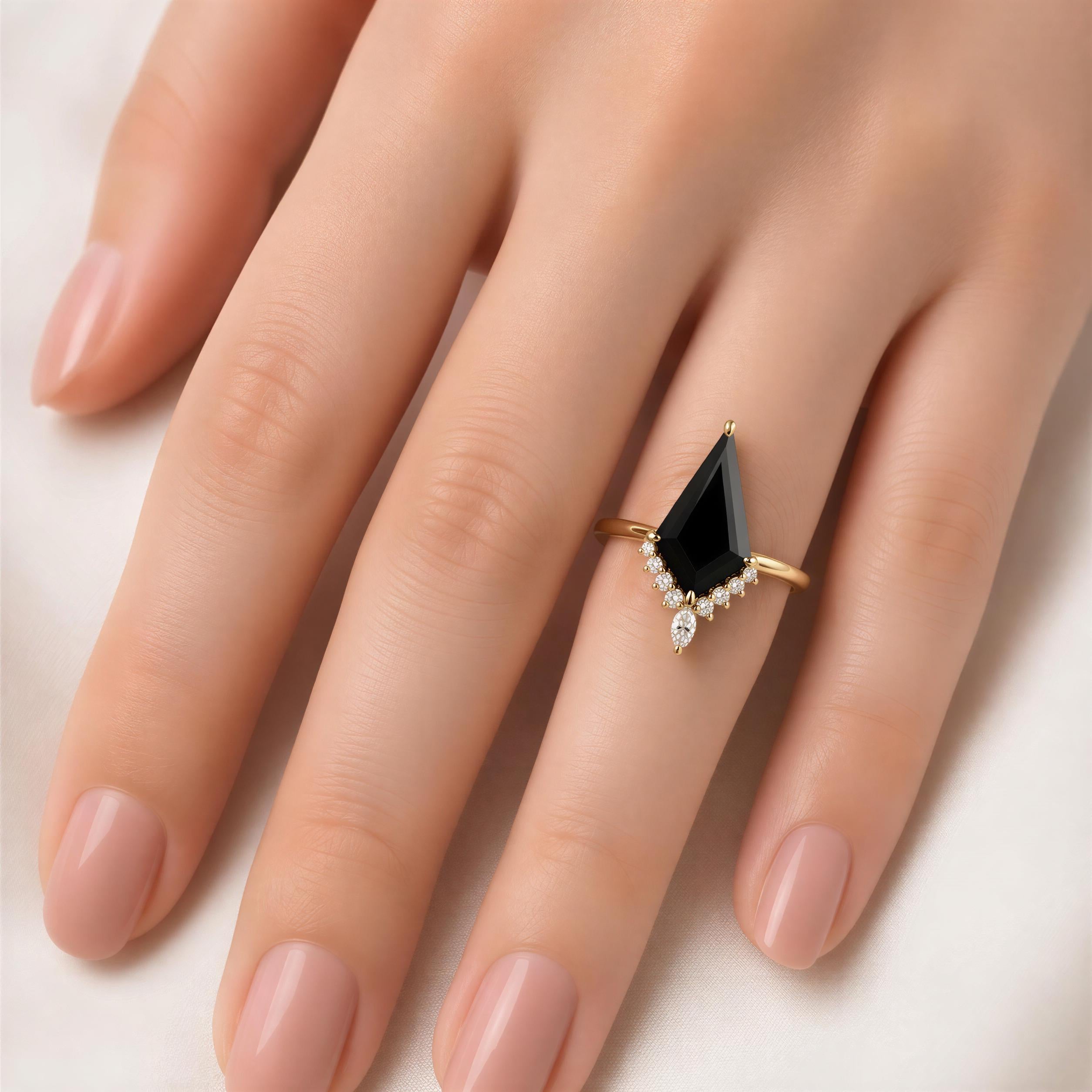 A close-up of a person's hand wearing a gold ring with a black gemstone, likely a diamond, set in a diamond-encrusted band.