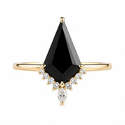 A gold ring with a large black diamond as the centerpiece, surrounded by smaller diamonds.