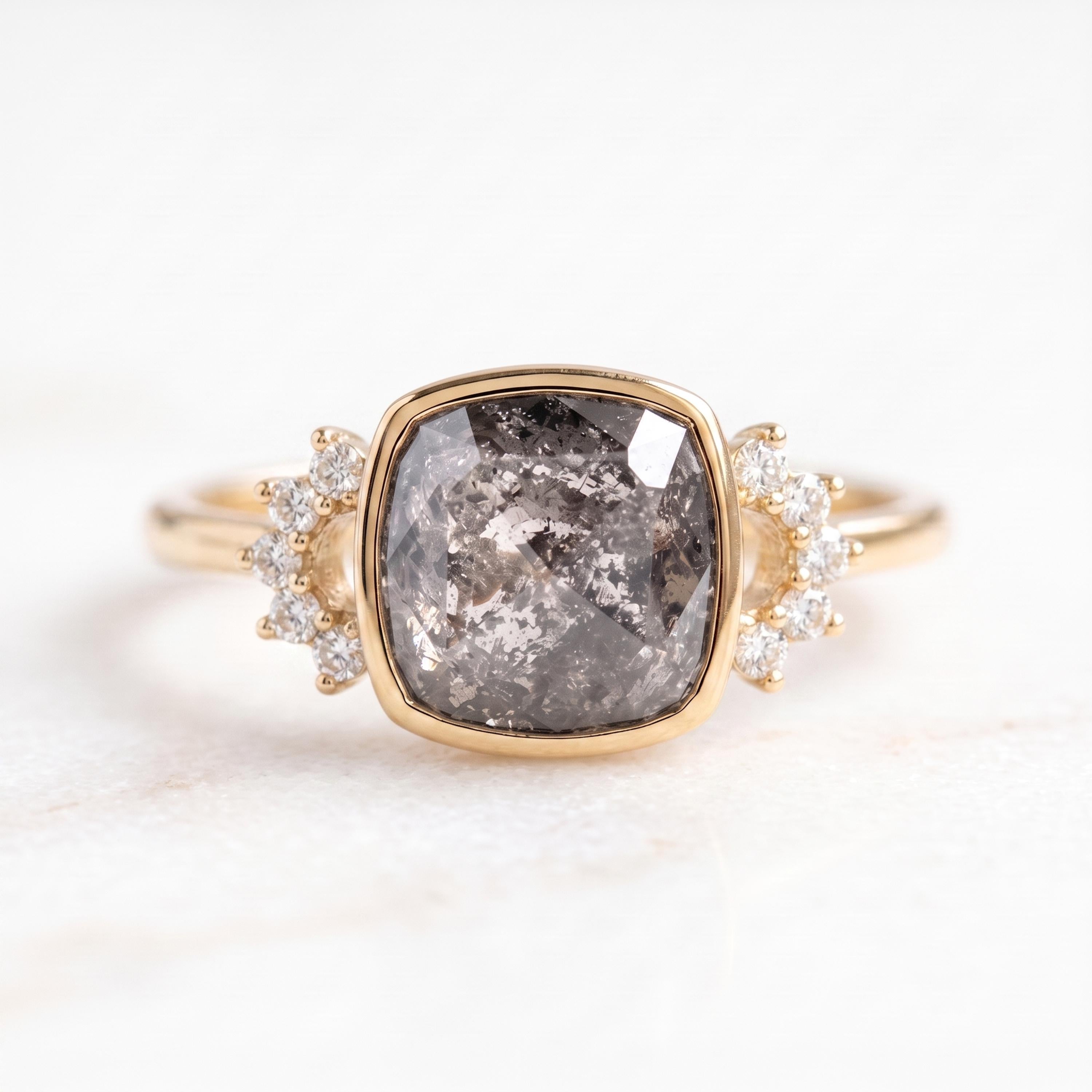 A gold ring with a large, square-cut diamond as the centerpiece, surrounded by smaller diamonds.