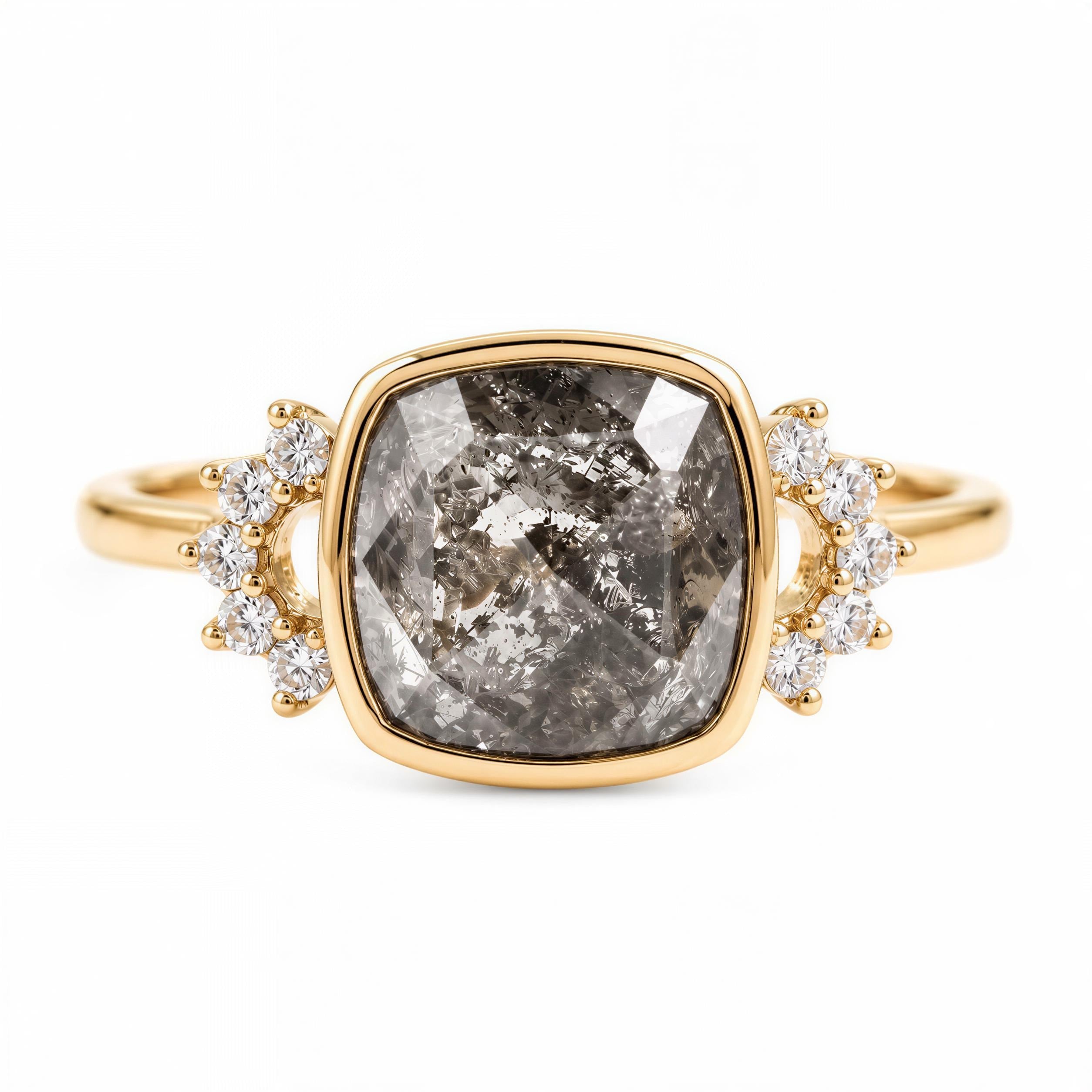 A gold ring with a large, irregularly shaped gray diamond as the centerpiece, surrounded by smaller diamonds.