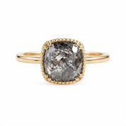 A gold ring with a large, irregularly shaped diamond as the centerpiece.