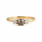 A gold ring with a large oval-shaped diamond in the center, surrounded by smaller diamonds.