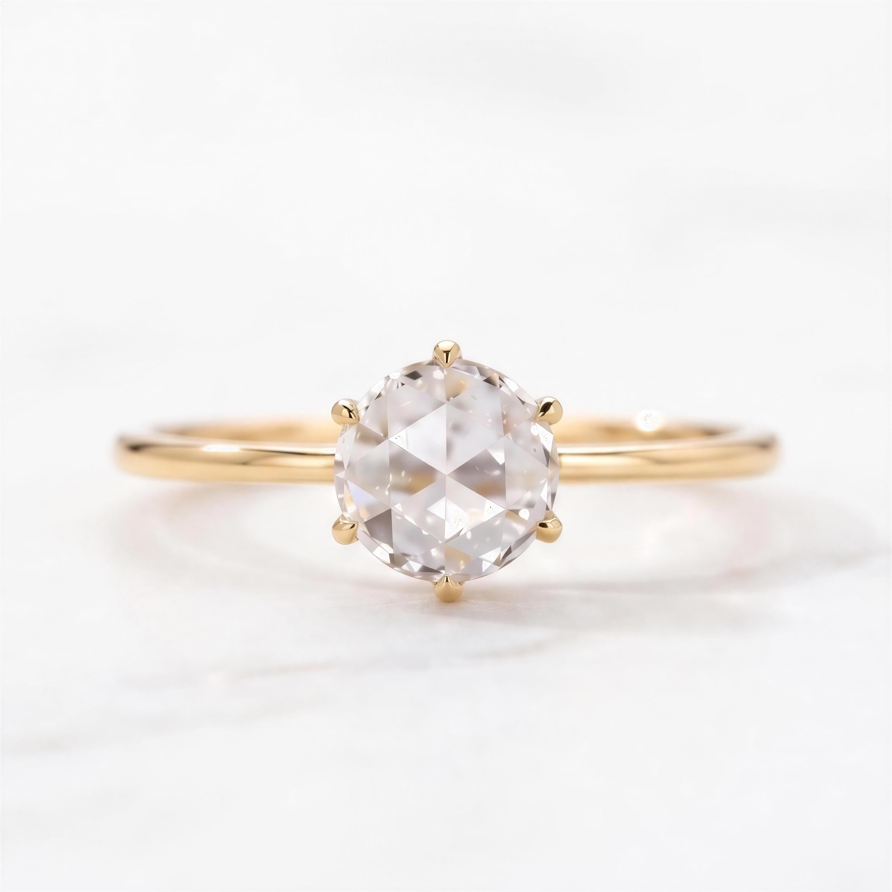 A gold ring with a large, clear gemstone set in the center.