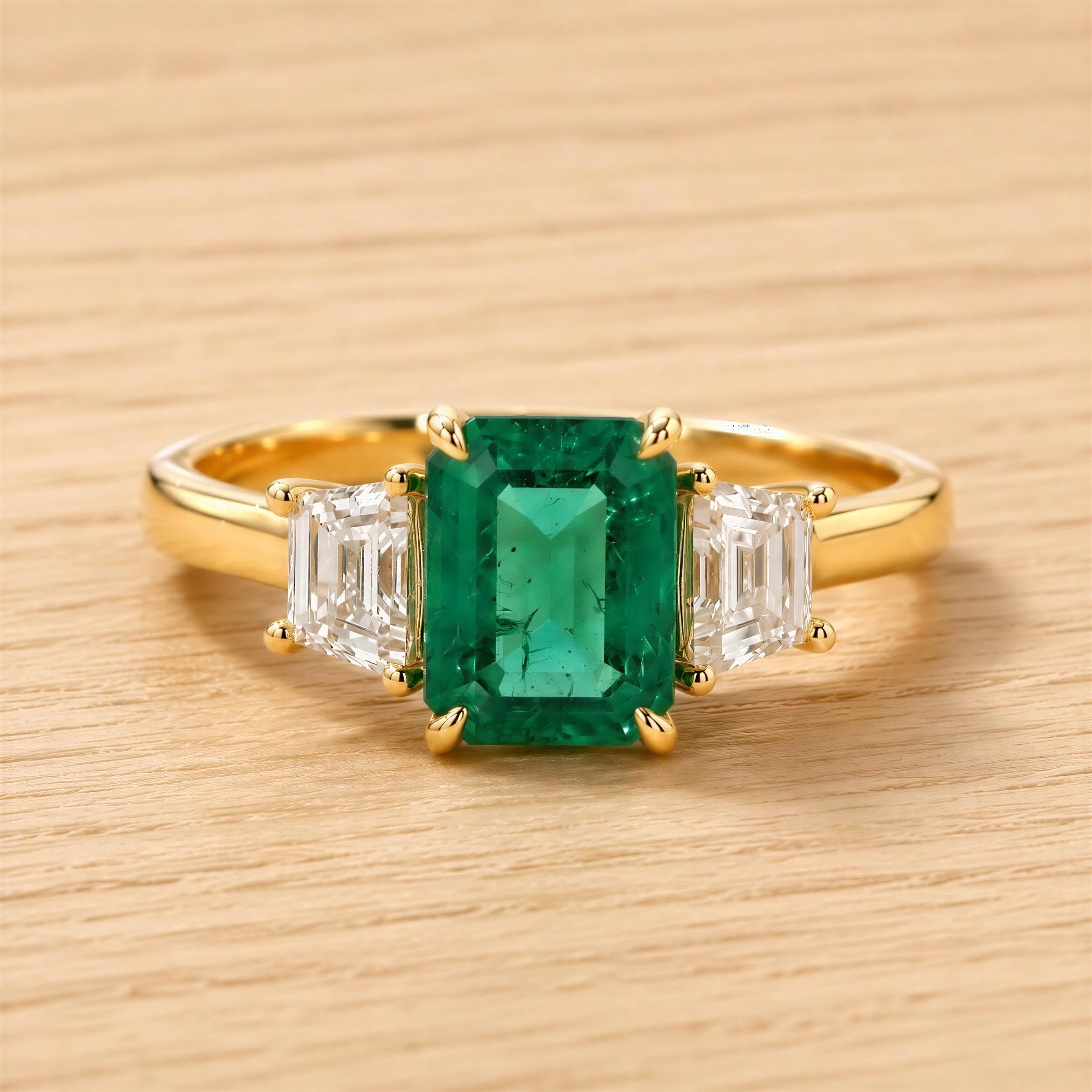 A gold ring with a large, vibrant green emerald gemstone in the center, surrounded by smaller diamonds.