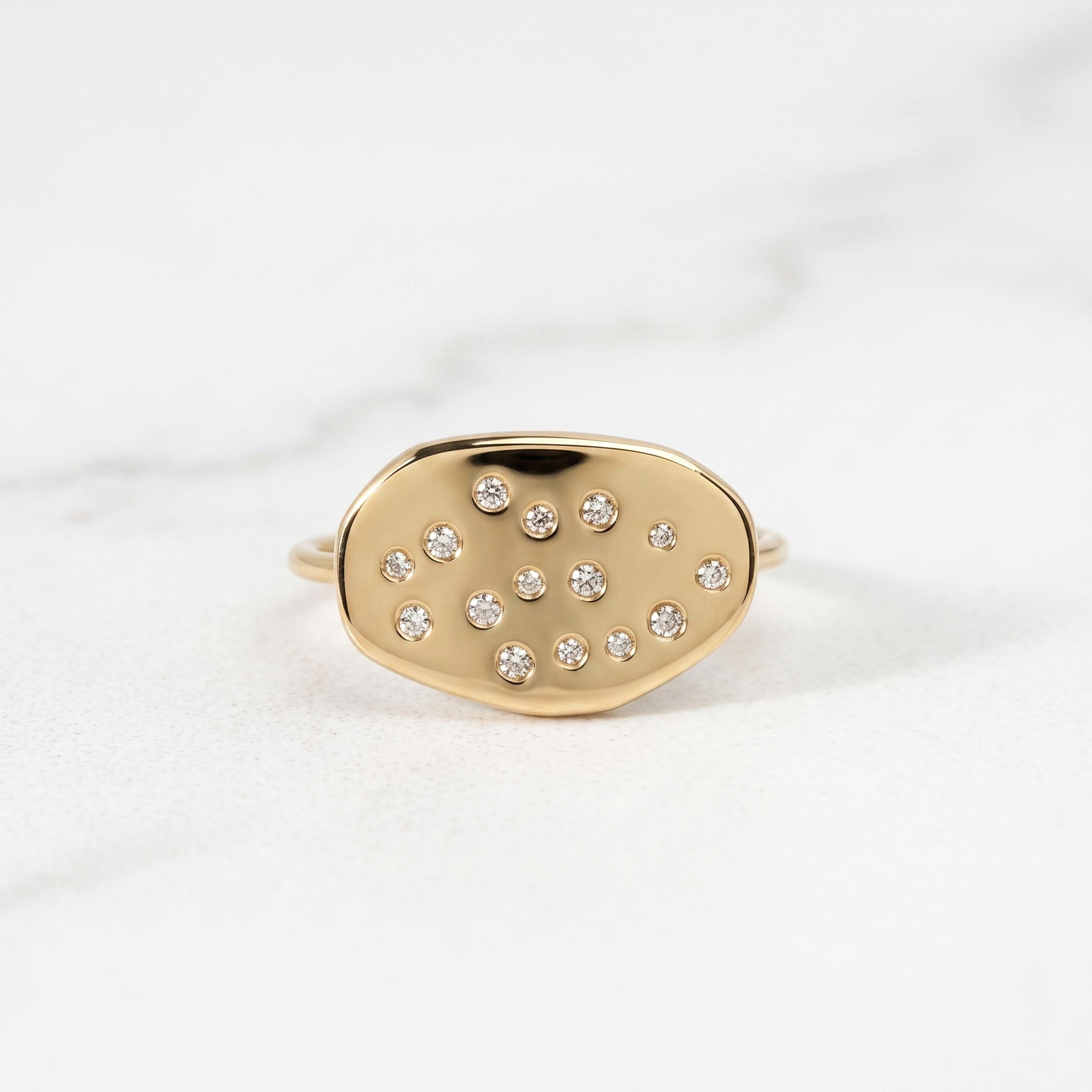 A gold ring with small diamonds set in the center.