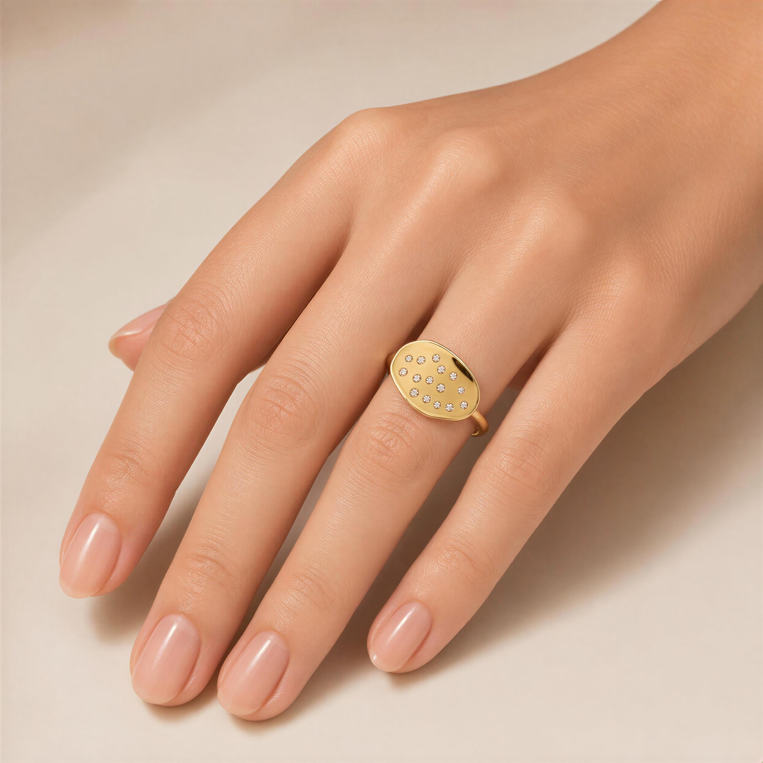 A close-up of a hand wearing a gold ring with small diamonds.
