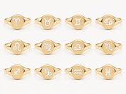 a collection of 12 gold ring designs, each featuring a different astrological sign symbol.