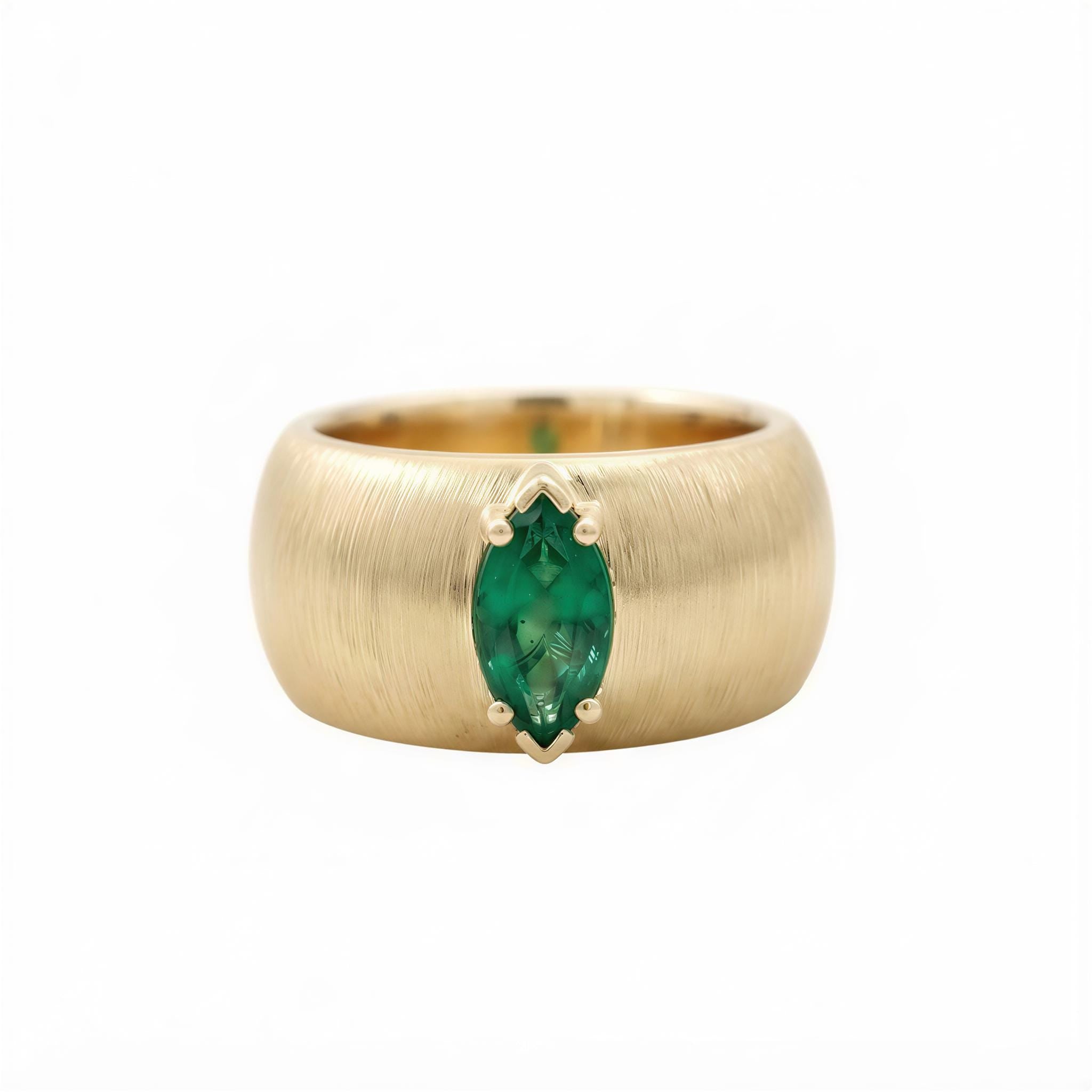 A gold ring with a large oval-shaped green gemstone set in the center.