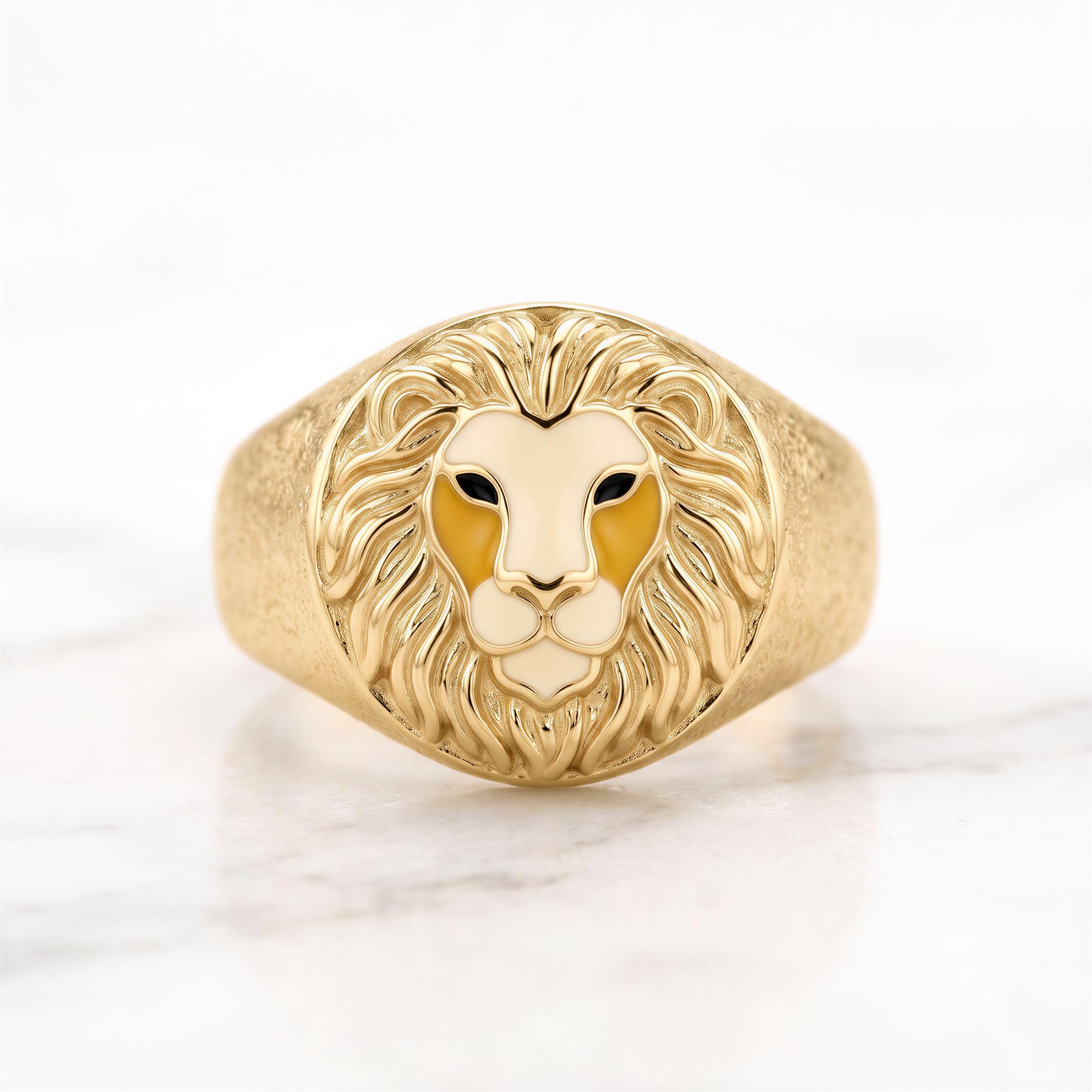 A gold ring with a detailed lion's head design.