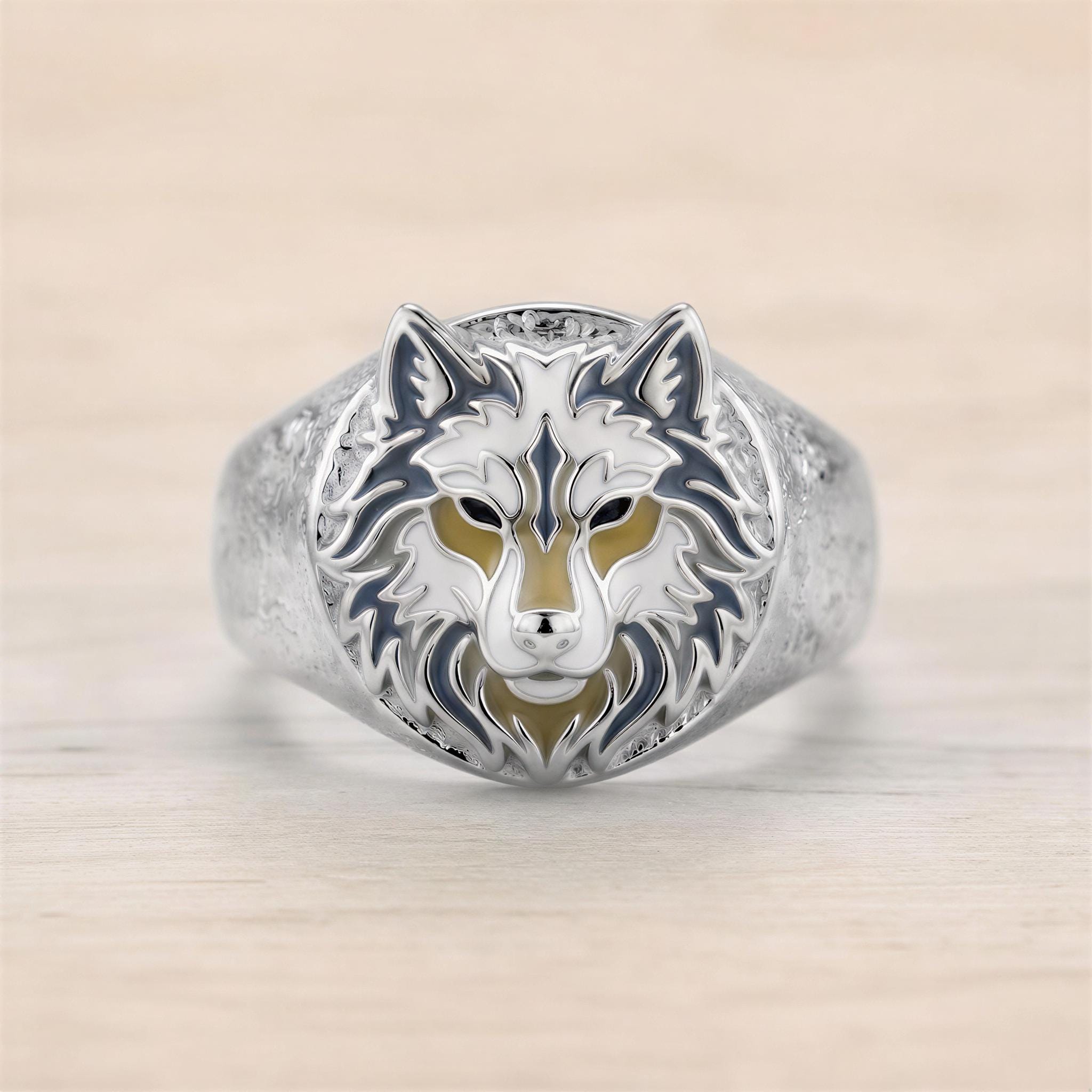 A silver ring with a detailed design of a wolf's head.