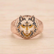 A gold ring with a detailed design of a wolf's head.