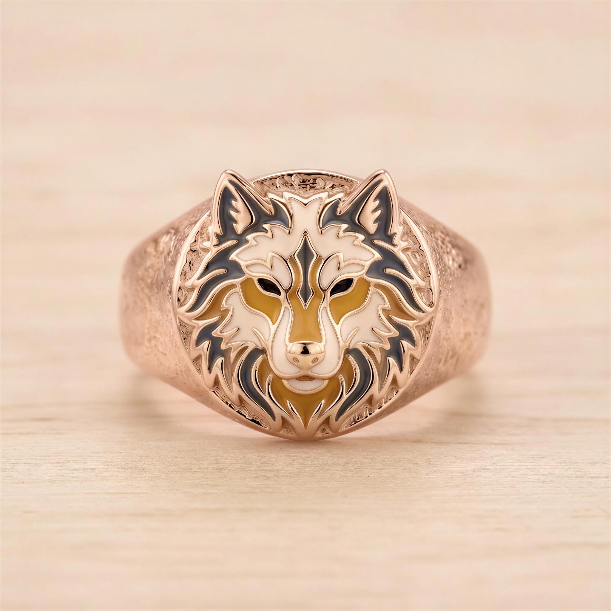 A gold ring with a detailed design of a wolf's head.