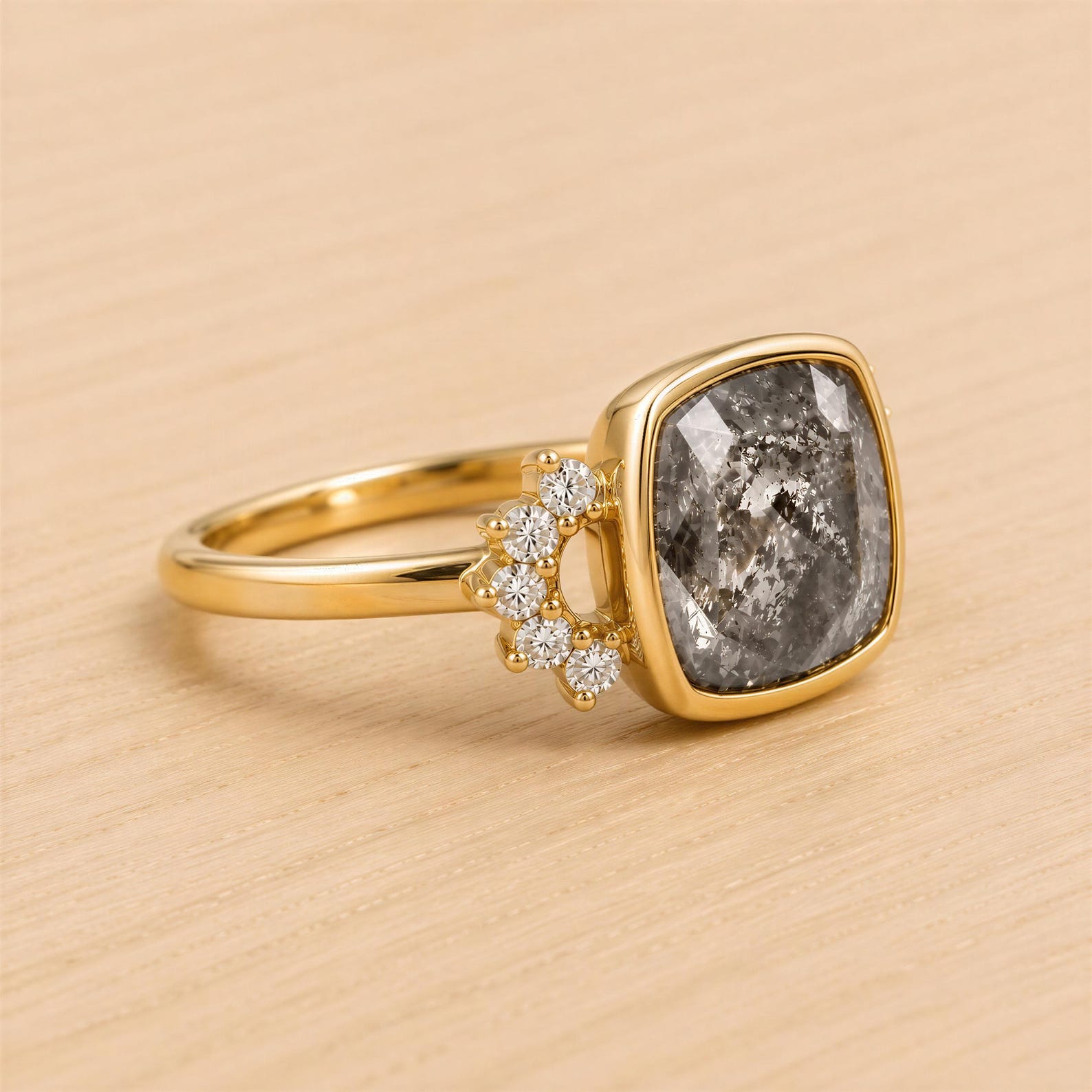 A gold ring with a large gray diamond in the center, surrounded by smaller diamonds.