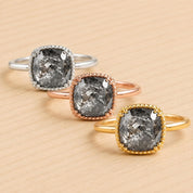 Three rings with large, irregularly shaped diamonds set in a gold, silver, and copper colored metal.