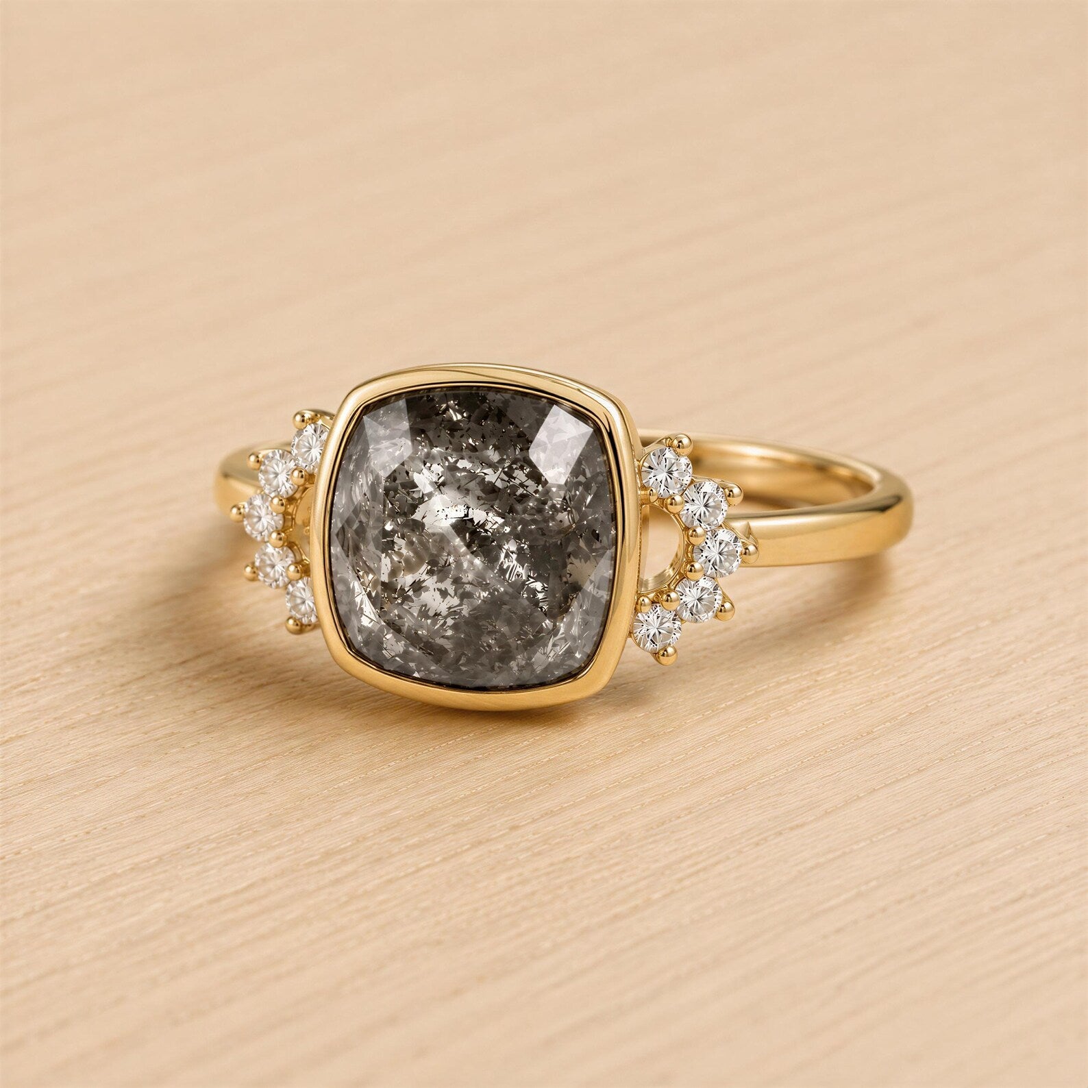 A gold ring with a large gray diamond as the centerpiece, surrounded by smaller diamonds.