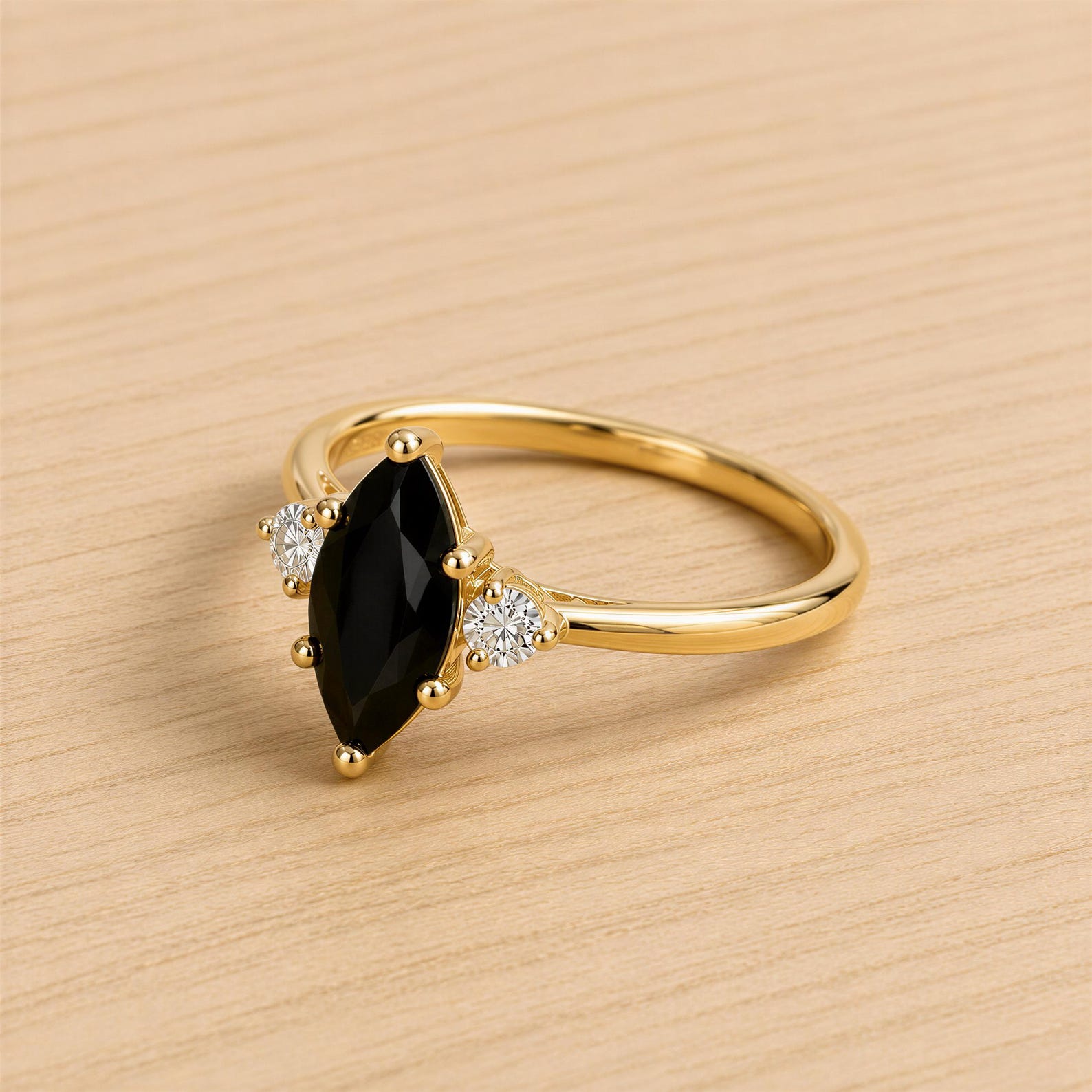A gold ring with a large black gemstone, possibly a diamond, set in the center.