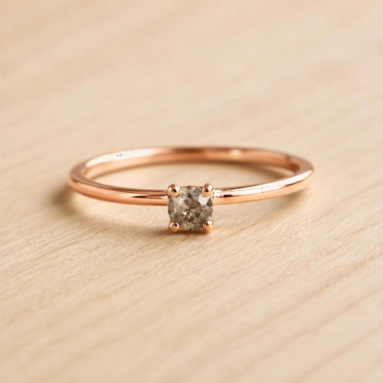 A simple gold ring with a small diamond set in the center.