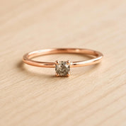 A simple gold ring with a small diamond set in the center.