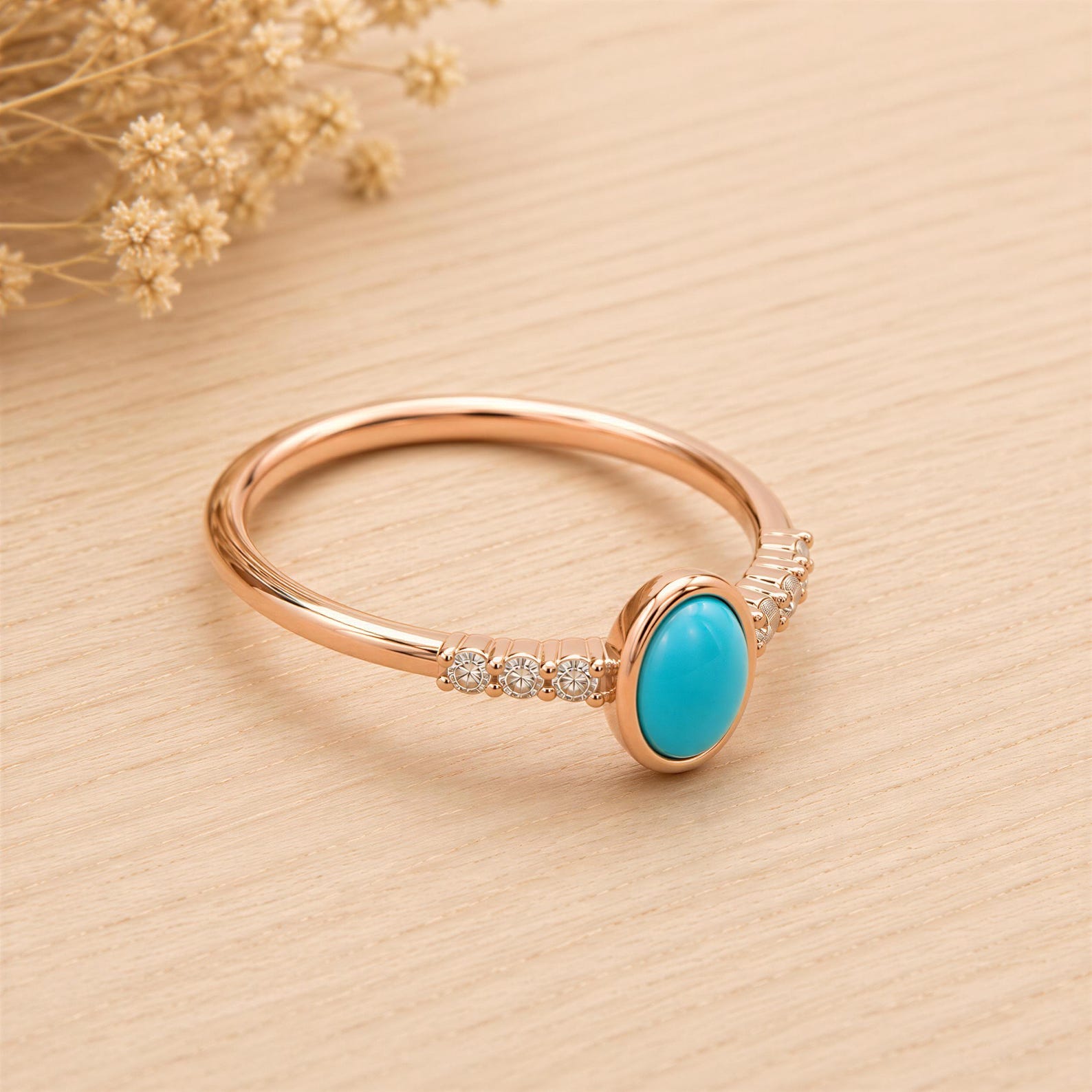 A gold ring with a turquoise stone set in the center, surrounded by small diamonds, placed on a wooden surface.