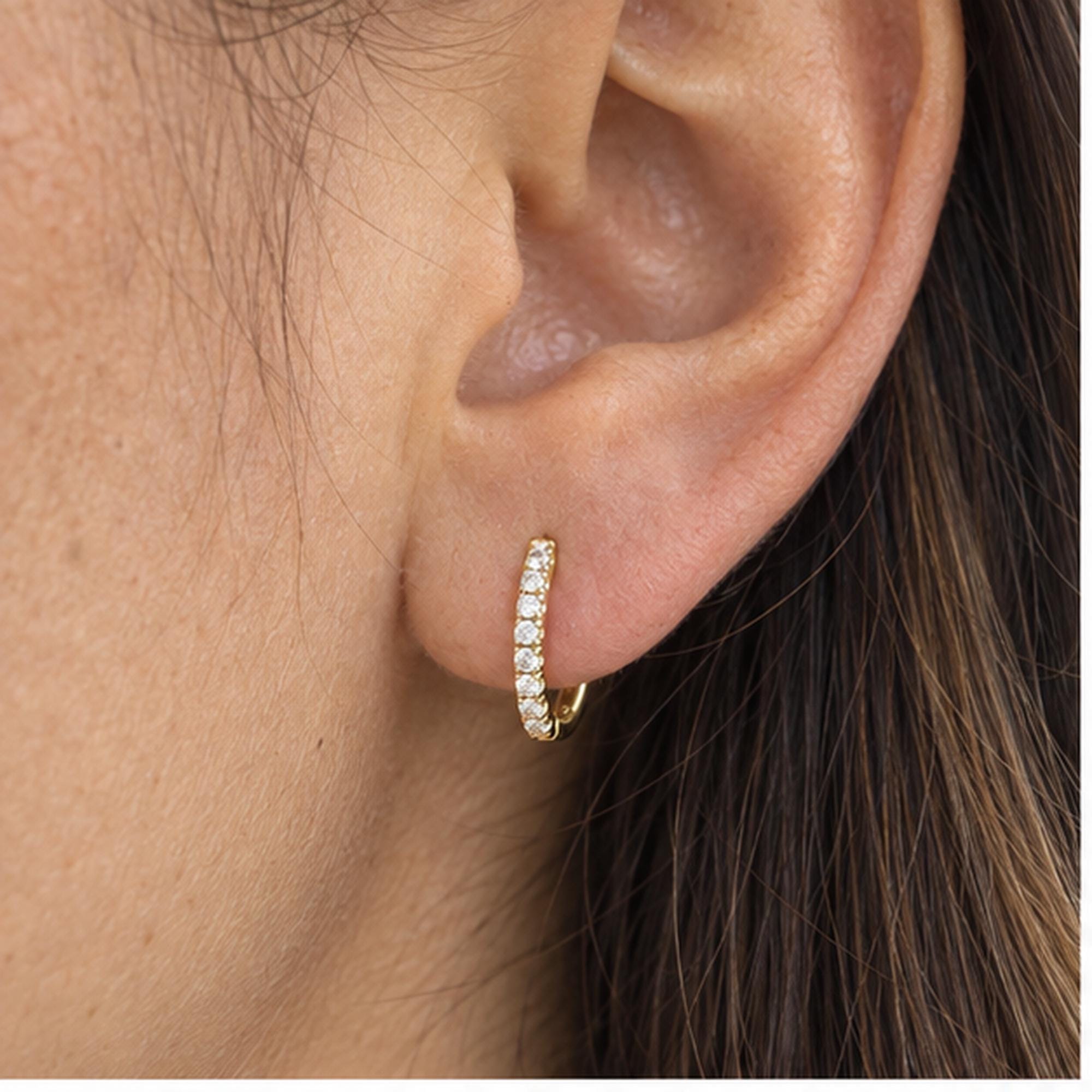 Natural diamond huggie hoop earrings, model ear view