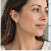 Natural diamond huggie hoop earrings, yellow closeup view