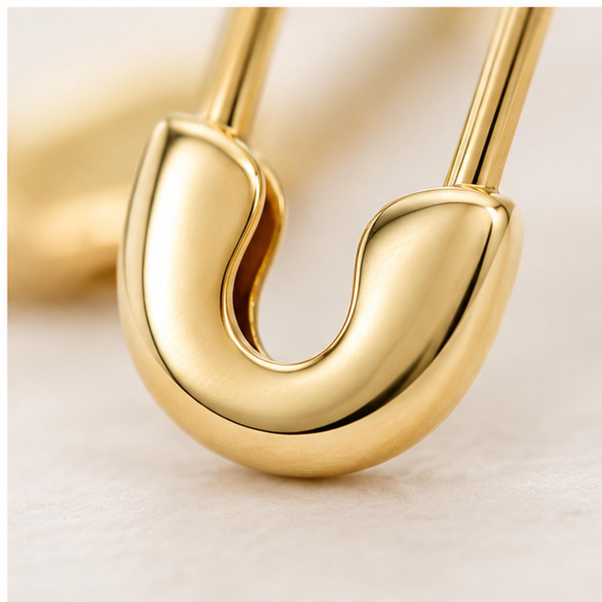 Solid gold safety pin earrings, closure detail view