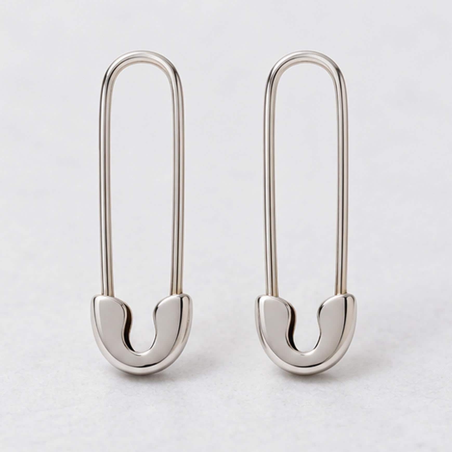 Solid gold safety pin earrings, white front view