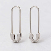 Solid gold safety pin earrings, white front view