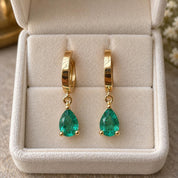Emerald drop earrings presented in jewelry box