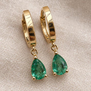 Hinged closure and back of emerald huggie earrings