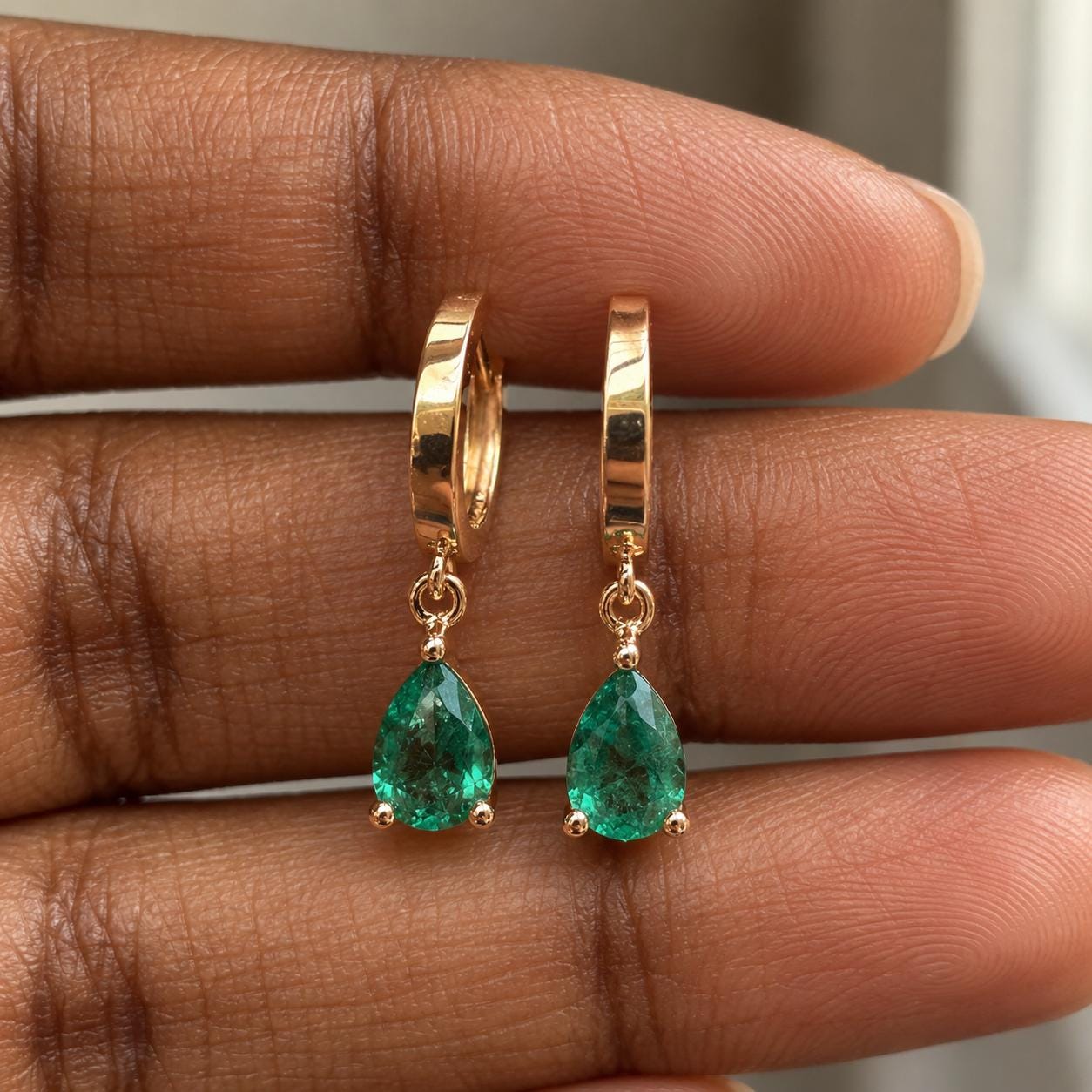 Detail of 14K gold emerald drop earrings