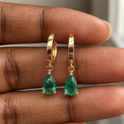 Detail of 14K gold emerald drop earrings