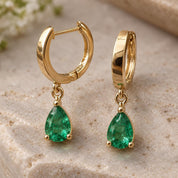 Emerald drop huggie earrings, side angle
